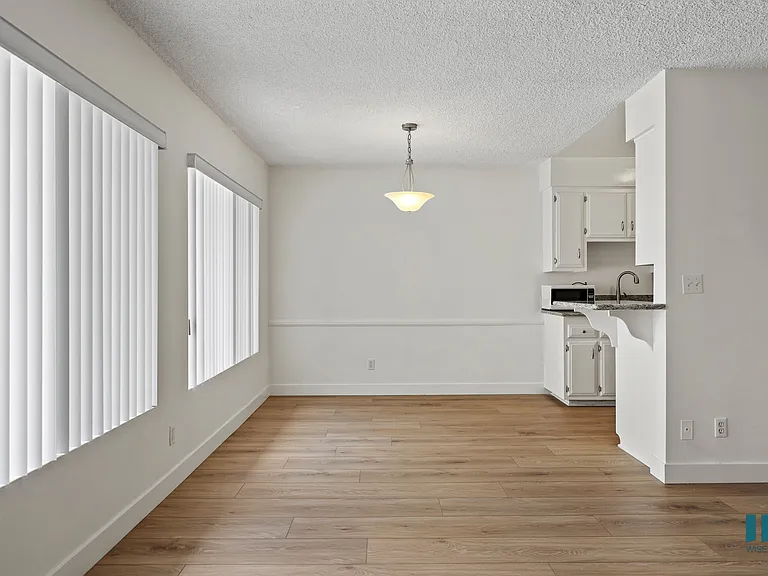 Dining Space with Large-Size Windows and Vinyl Flooring