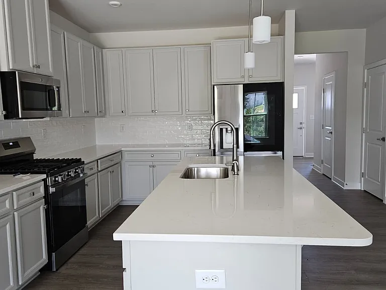 Gourmet Kitchen with Quartz countertop and LG instaview refrigerator