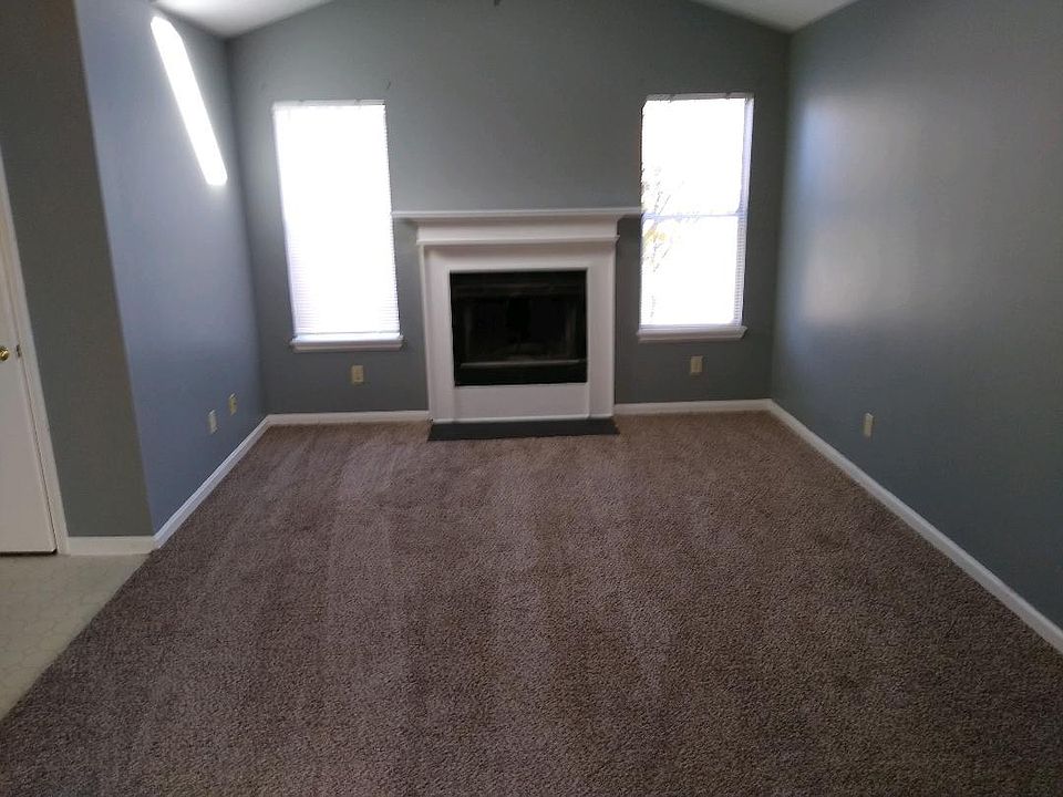 Living room with fireplace. Newly painted and new carpet.