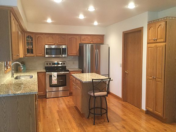 Granite countertops, tile backsplash, new faucet and sink featured in the kitchen with separate island for cooking preparation and plenty of storage - all appliances stay and are brand new...just installed and look great!  Hardwood floors provide much warmth to the room