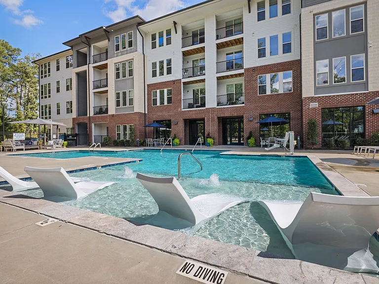 Relaxing Pool Area Featuring Tanning Ledge and Soaking Loungers