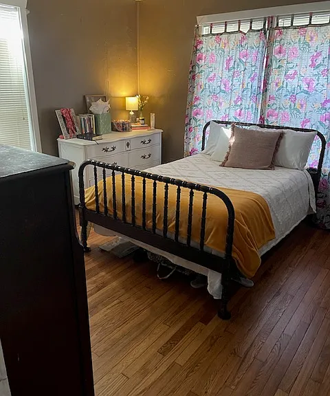 bedroom with hard wood floors and tons of light