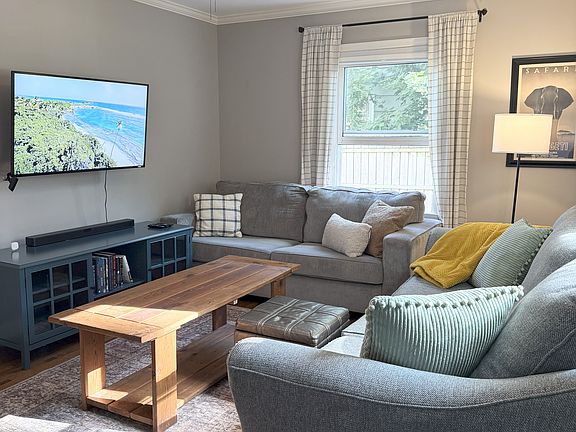 Cozy living room with two couches, ottoman and a coffee table.