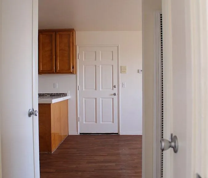 View from bedroom into living area and front door
