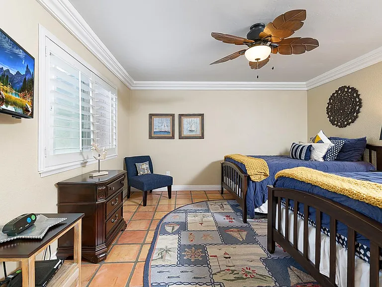 Guest bedroom featuring 2 full beds and a flat-screen TV.