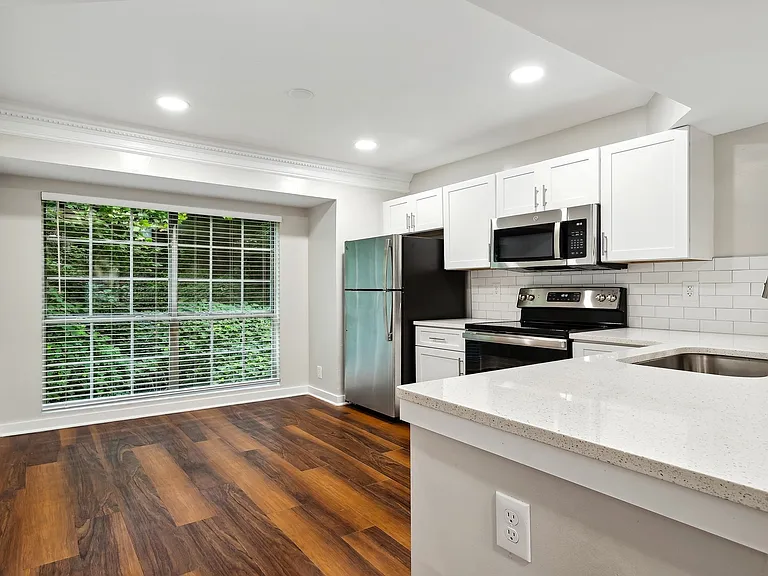 Large kitchen with stainless steel appliances, breakfast bar and great natural lighting