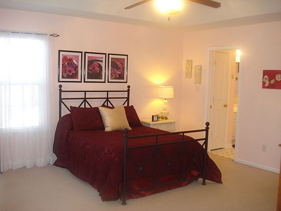 Master bedroom with separate sitting area, trey ceiling & fan