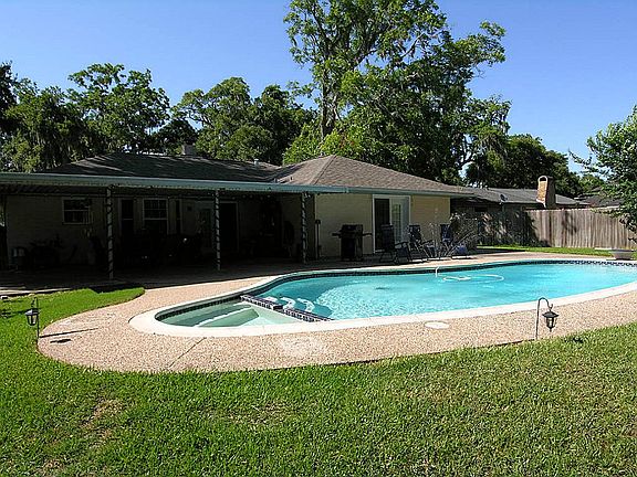 The back yard is the gathering place and offers a beautiful pool, hot tub, covered patio