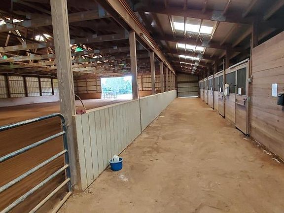 14,000 sqft Morton built equestrian barn complete with 7 12'x12' stalls, 2 12'x18' foaling stalls, 70' x 142' covered riding area, sprinkler / fly /lighting system