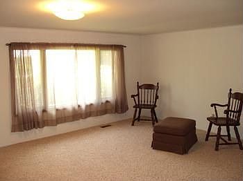 Freshly painted living room with new carpeting.