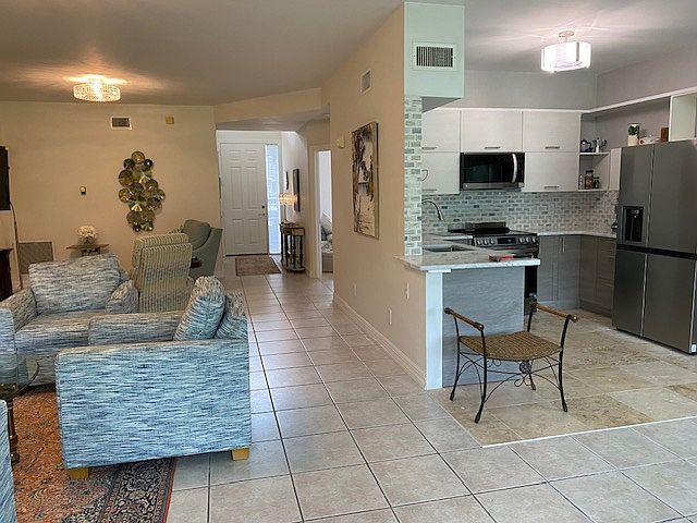 Kitchen and sitting area looking towards entrance door.