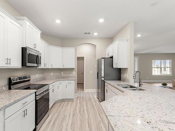 Enjoy an open kitchen with a counter-height breakfast bar - Westin II by Highland Homes