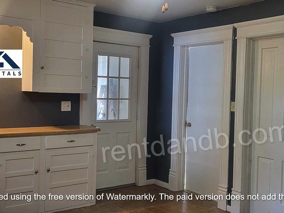 Kitchen view to exterior door, office, and walk down basement.