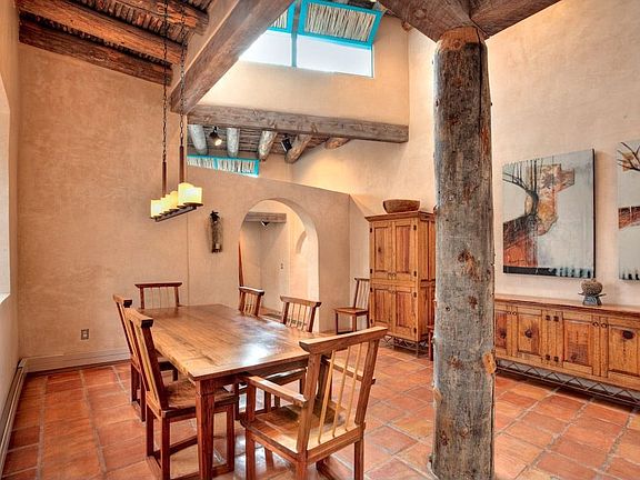 Off the foyer, partially concealed by a creative dividing wall, is the dining room, which is defined