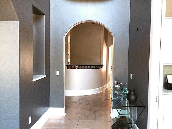 A high ceiling greets you as you enter the foyer with beautiful marble floors