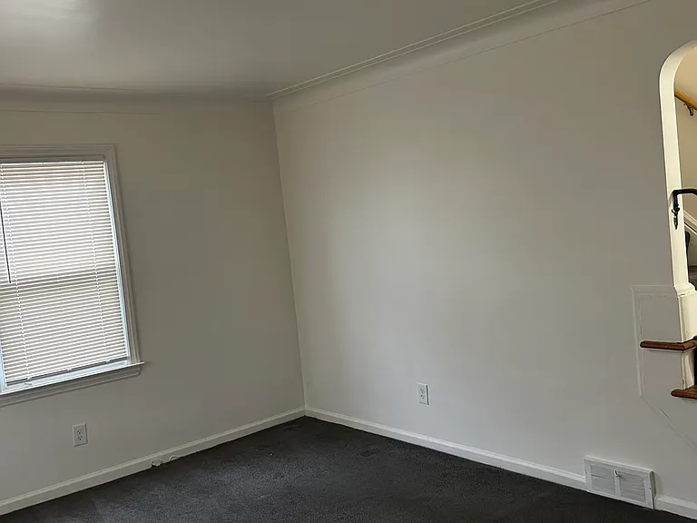 Open living space with direct access to upper level and flexible layout options.