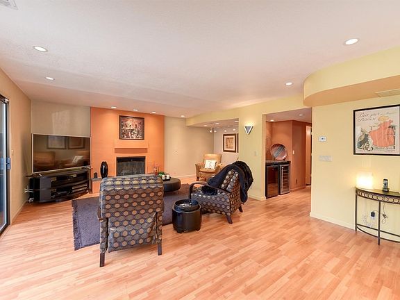 Living room with fireplace, nook and wine storage in hall.
