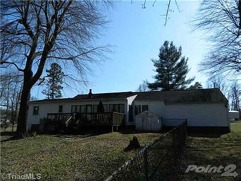 Rear of Home with Deck and Sunroom