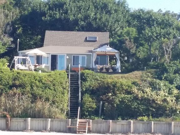 View from the beach. Cabana on right. A wooden swing where you can watch the sunsets