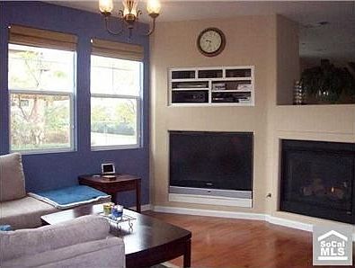 Family room with built-in entertainment center and gas double-sided fireplace