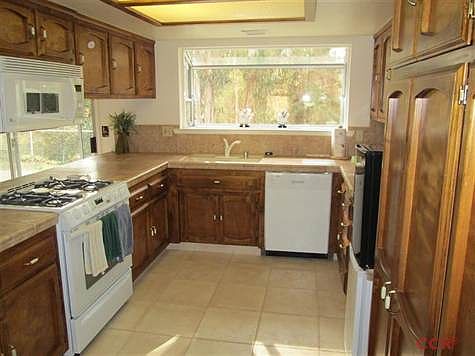The counter tops and the flooring of the kitchen have been replaced and new appliance added. Also, there are plenty storage cabinets.