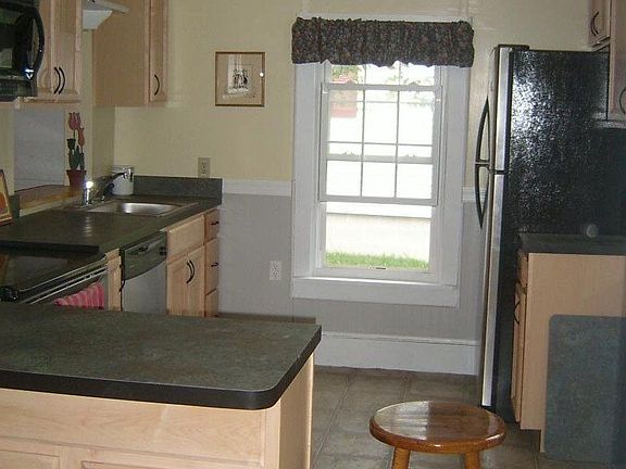 new kitchen with maple cabinets and stainless steel appliances