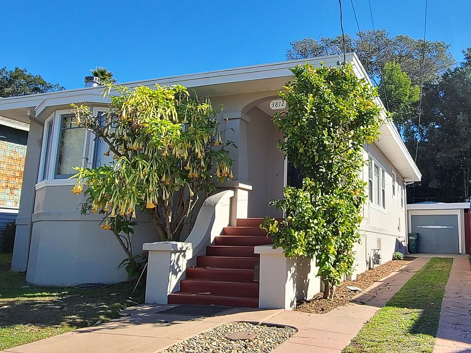 Front of the house with driveway and garage entrance.