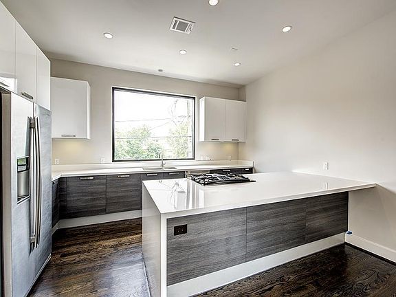 Modern, sleek kitchen with European-style cabinetry and unde