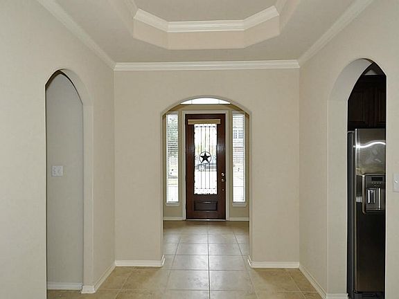 This entry way leads all the way back to the family room and is characterized with beautiful trim and crown molding.