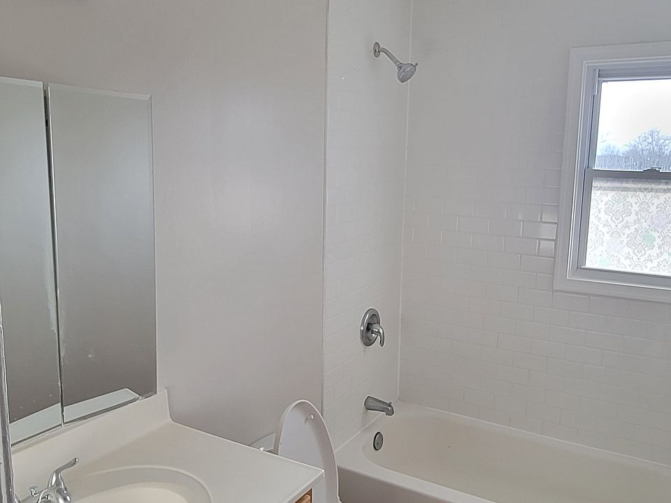 Bathroom with tub and window