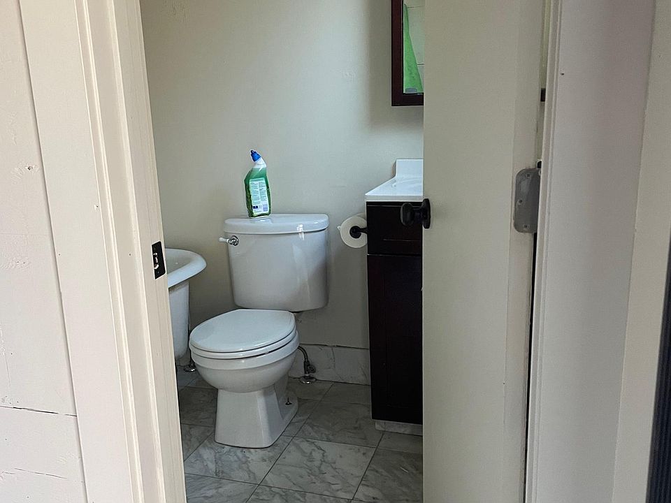 Clean bathroom with clawfoot tub/shower.