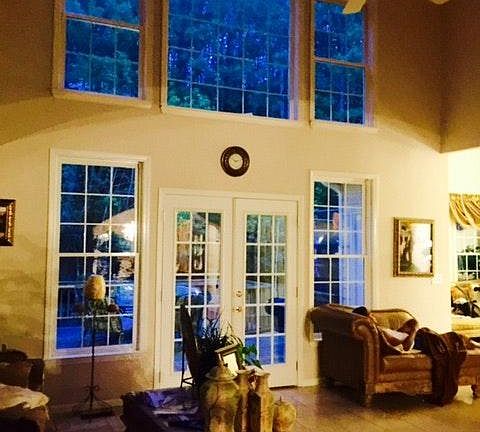 Large 2 Story Family Room With a Wall of Windows