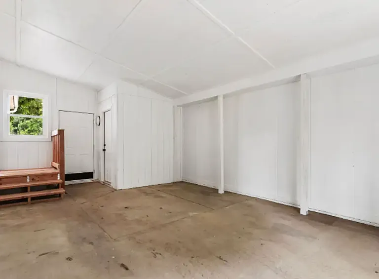 Large breezeway between garage and house for hobbies, storage, or extra space.