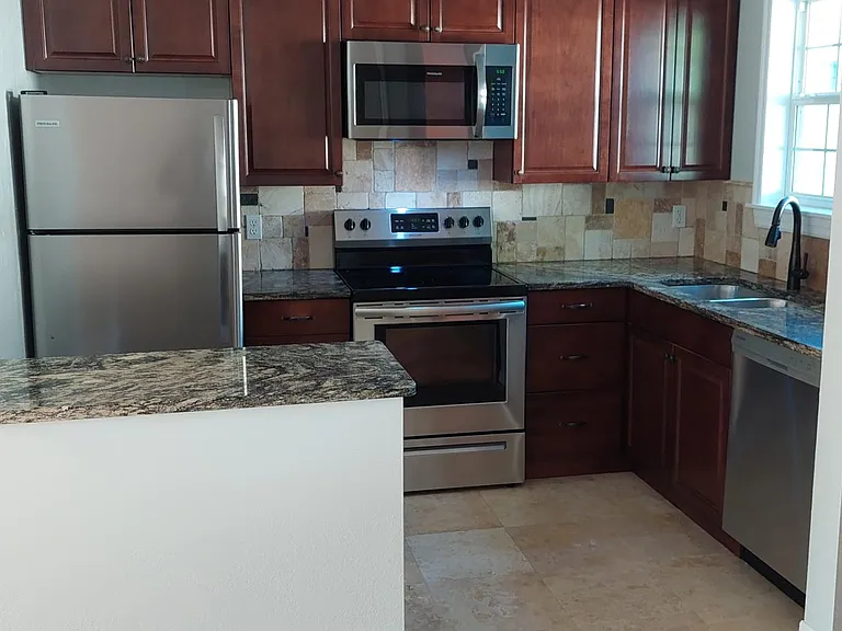 Custome cabinetry with full length extension drawers and built in waste bins.