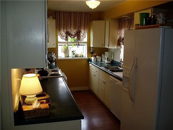 Newly refinished cabinets, laminate floors and garden window