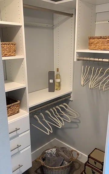 Walk in closet with built ins, including drawers.