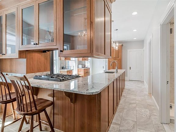 Breakfast bar backs up to dining area, bedrooms, bathrooms on right side (door at end of kitchen is 1/2 bath).