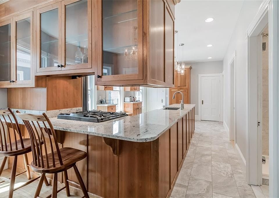 Breakfast bar backs up to dining area, bedrooms, bathrooms on right side (door at end of kitchen is 1/2 bath).