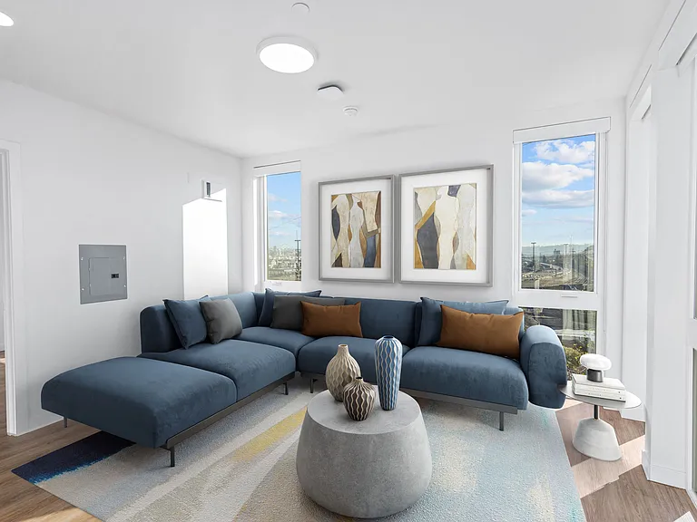 This cozy living room features a comfortable blue couch and a round coffee table, creating a welcoming space for relaxation.