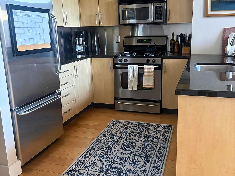 Kitchen with gas stove and stainless appliances.