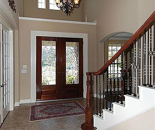  Leaded glass double doors open to this lovely two-story foyer.