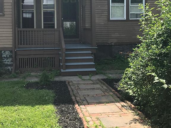 Walkway and porch lead to private entrance.