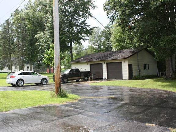 3 Car garage (30x40) is insulated and heated with a propane furnace. There are 2 overhead doors on the front and 1 on the side. Lots of parking with circular asphalt driveway!