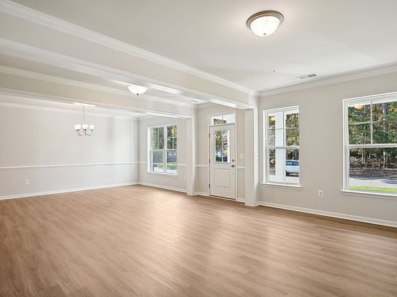 The entrance, dining room and living room of the Kendrick on homesite 3032 at Swan Point.