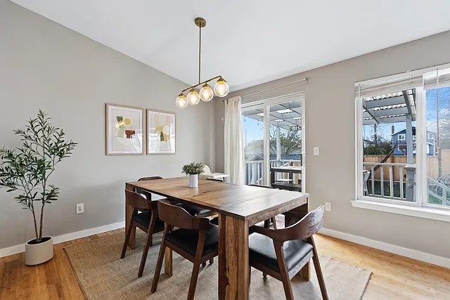 Open dining room that leads to the covered deck and backyard