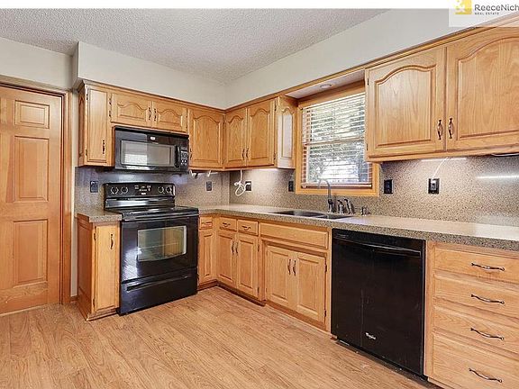 Kitchen which offers granite counters, black appliances and under counter lighting .  Kitchen is plumbed for gas.