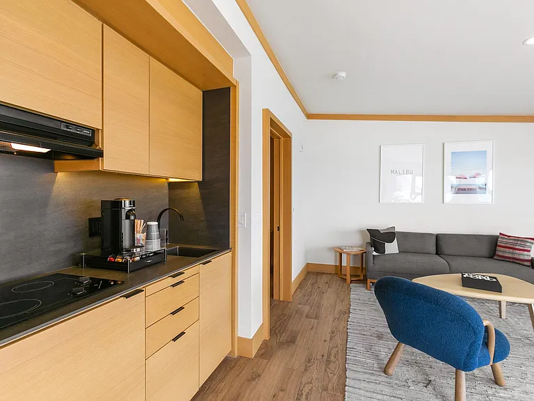 A fully stocked kitchenette with mini-fridge and freezer, cooktop, coffee station with pods, toaster oven, kettle and Ninja blender.