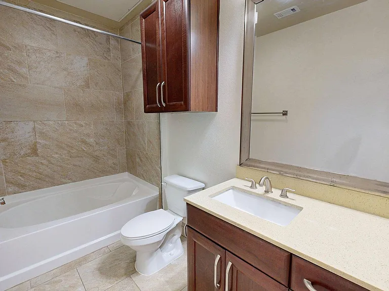 Apartment Bathroom with large soaking tub and Tile Flooring.