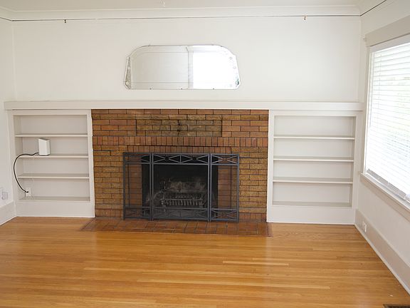 Wood burning fireplace with built-in book shelves.