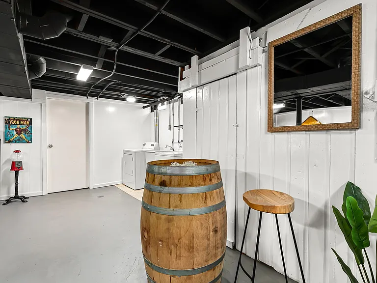 The wooden barrel provides a unique and inviting focal point, and the stools are perfect for sitting and chatting with friends.